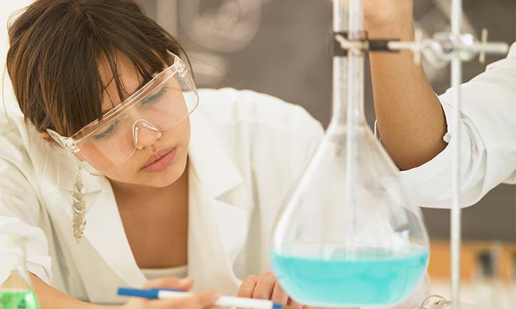 Photo: stem student analyzing chemicals in a beaker