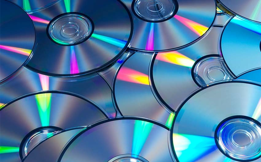 Photo: close up shot of compact discs stacked on top of each other