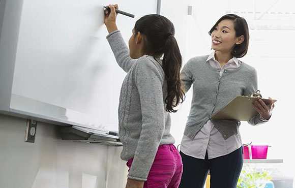 STEM Education Group of students at whiteboard.