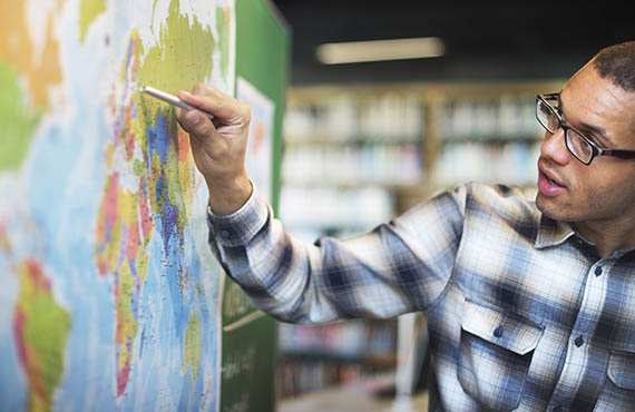 STEM Innovative Leaders Male teacher at map.