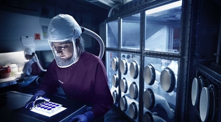 Explore-Careers-at-Battelle Photo: Battelle epidemiologist workign in Biosaftey Level 3 lab