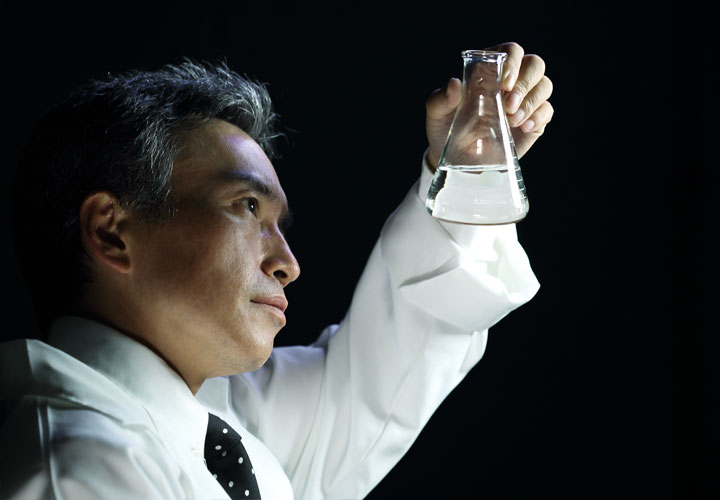 Photo: Battelle analytical chemist researching PFAS in a flask