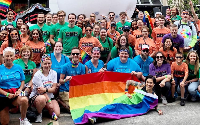 Photo: Prism ERG posing with pride flag