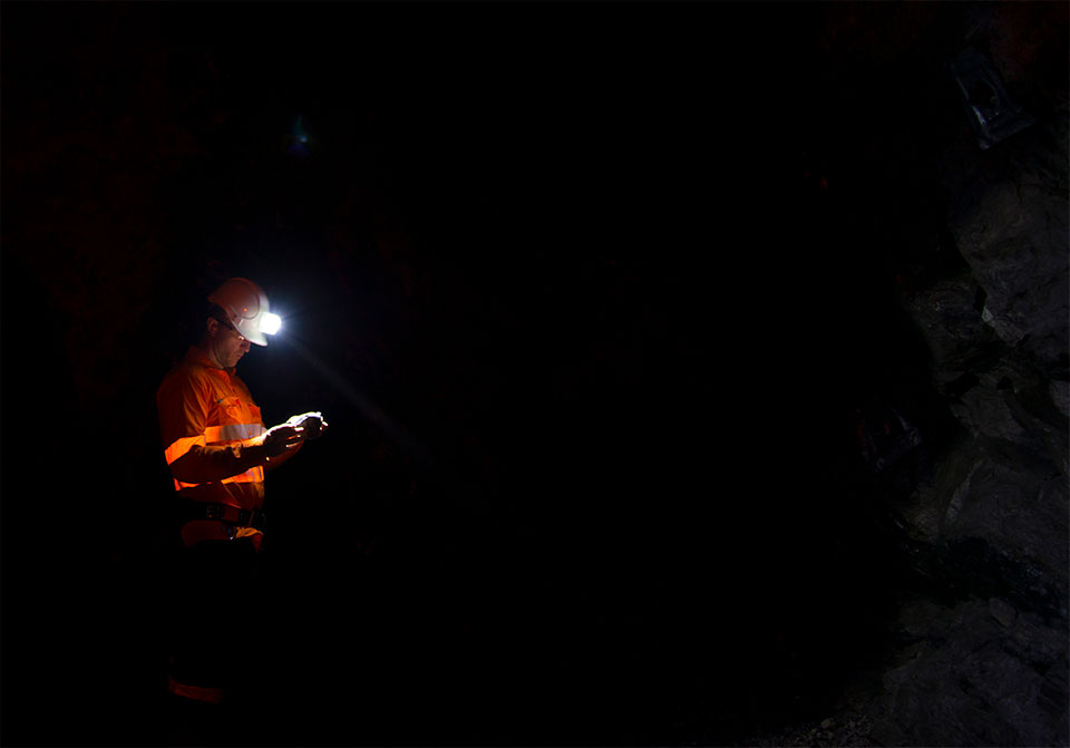 Photo: Geologist examining underground rock