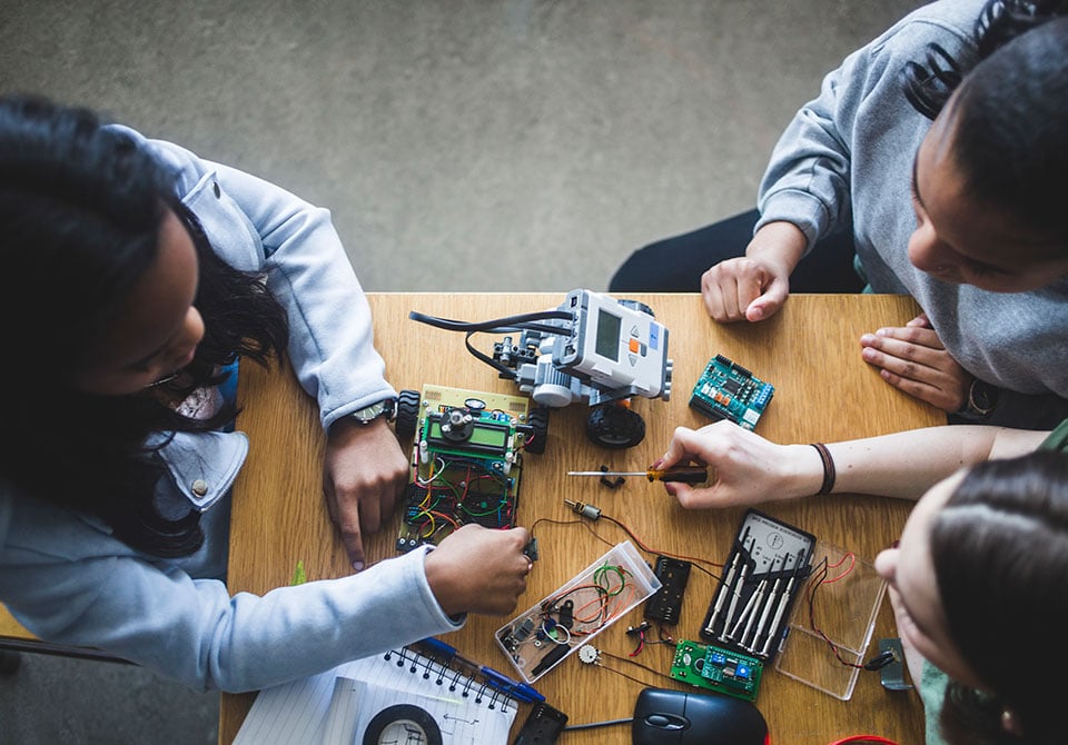 Photo: Two STEM Students working on a microelectronics trust project