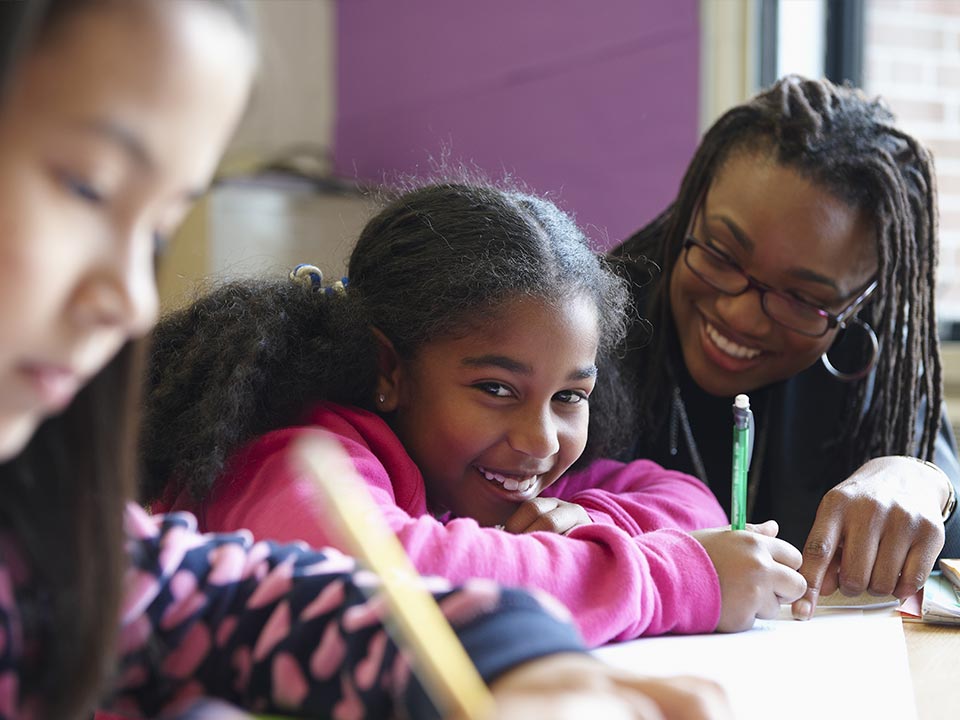 stem-who-we-serve alt= a stem student being helped with their classwork by their teacher