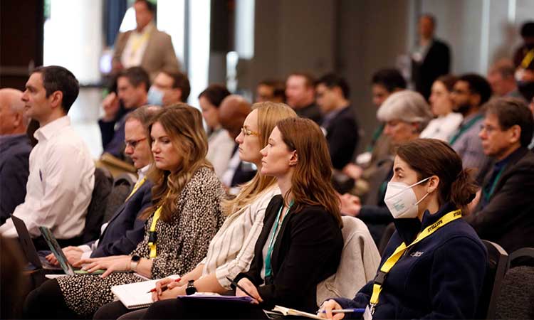 Photo: crowd listening to a presentation at the conference on innovations in climate resilience