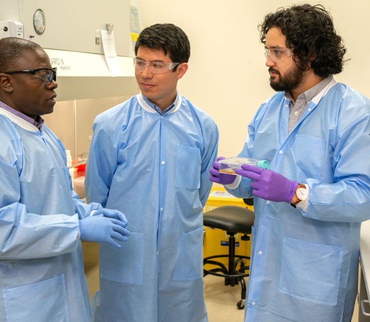 Photo: Three Battelle Solvers discussing a carbon carbon application for a hypersonics solution