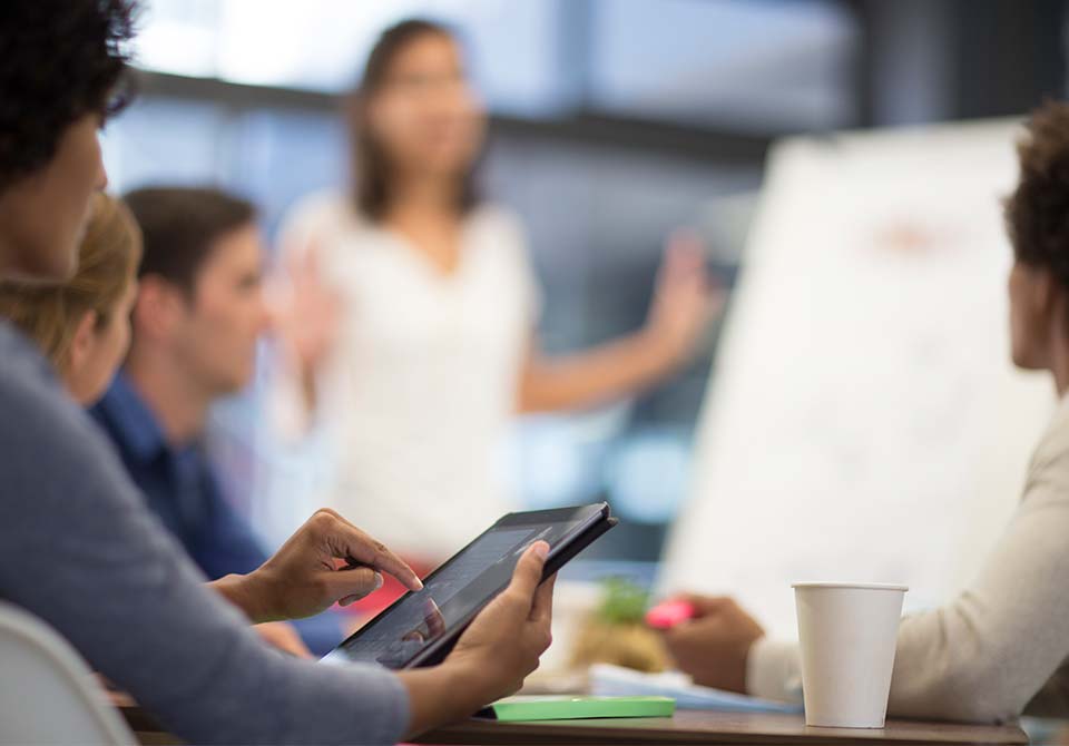 Photo: two people shaking hands in a meeting