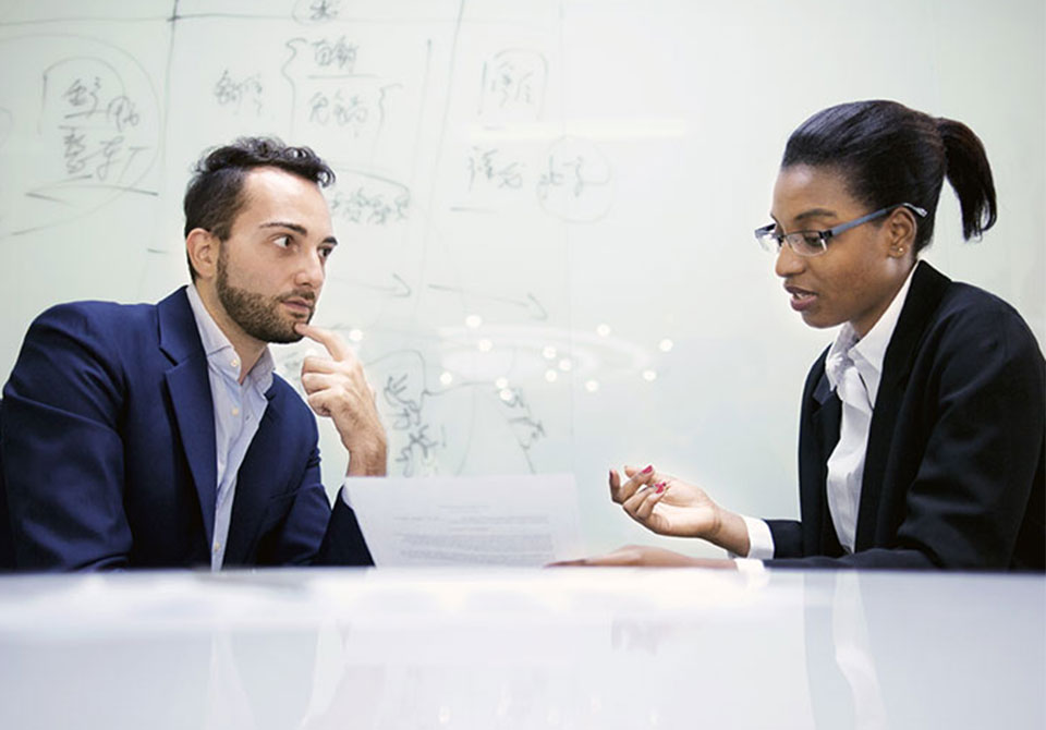 govt-clients alt= an account manager seating down with their government client to discuss a contract vehicle