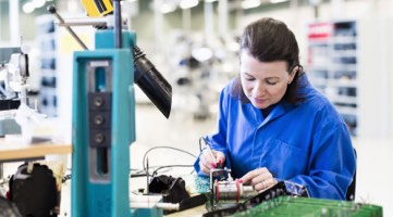 Photo: Electrical engineering working on a piece of hardware.