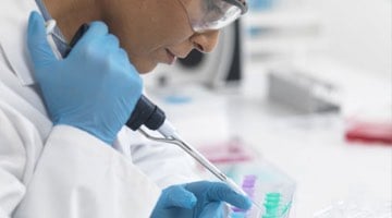 Photo: Researcher examining samples using a probe-like tool.