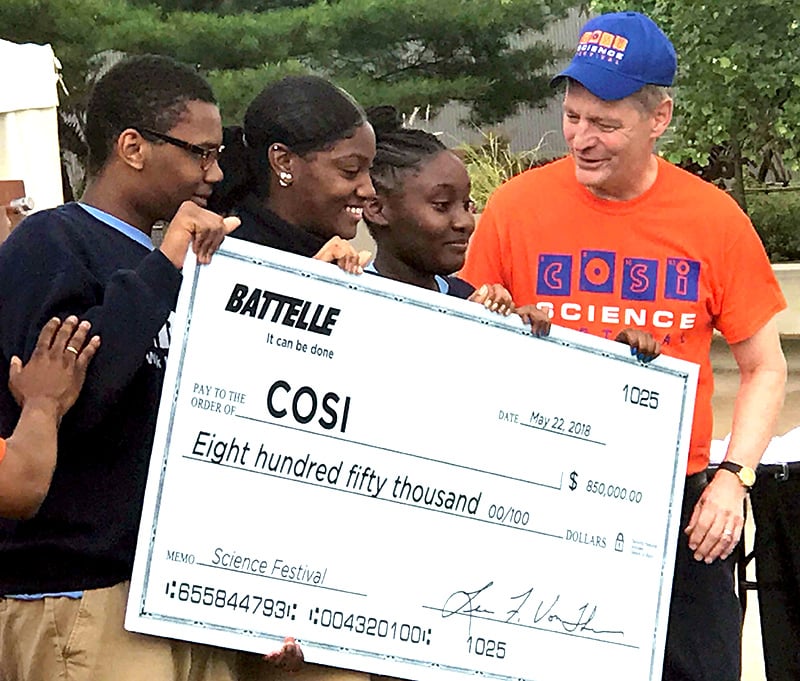 alt= lou von thear presenting a check to cosi