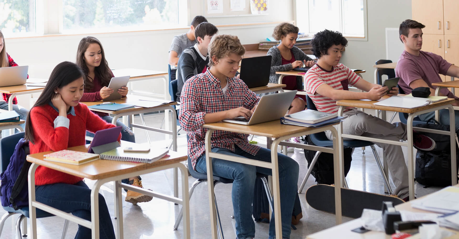 alt= high schoo students working in a classroom