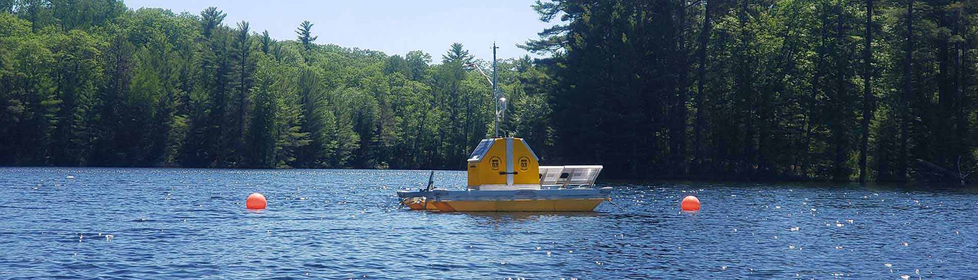 Photo: NEON researchers in a boat conducting work in a lake.