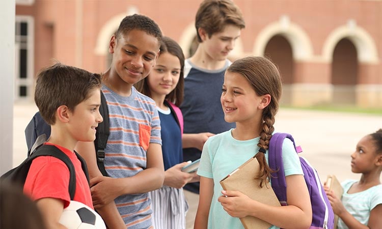 alt= students talking at their after school program