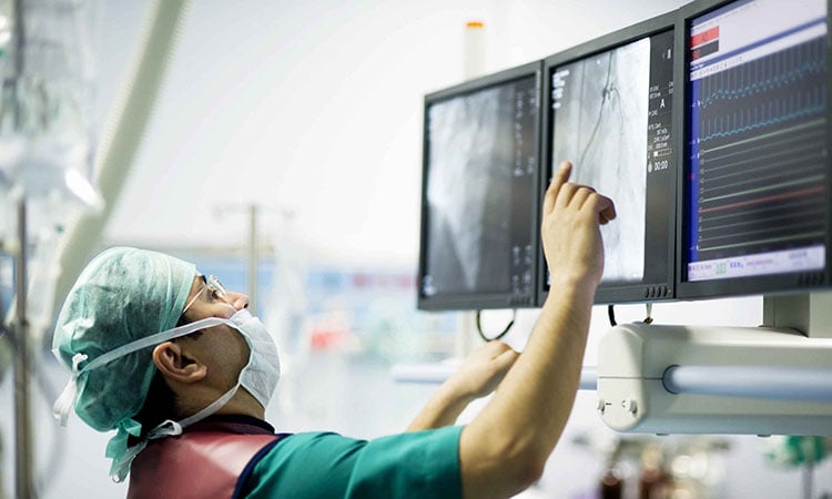 Photo: Health professional examining data on a screen