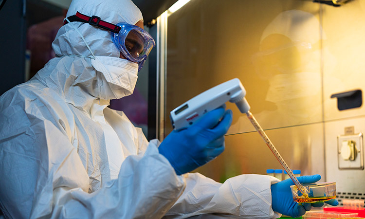 Photo: Lab worker wearing PPE