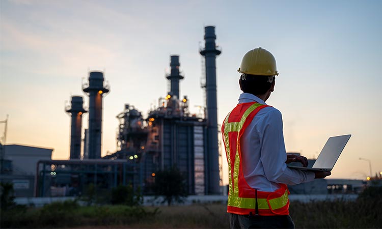 Photo: carbon storge services site manager looking at a power plant