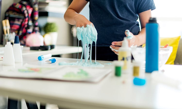 Photo: Child playing with paste-like compound