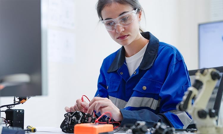alt= electrical engineer student soldering intricate robotic components on a circuit board or an electronic device workshop in a laboratory room
