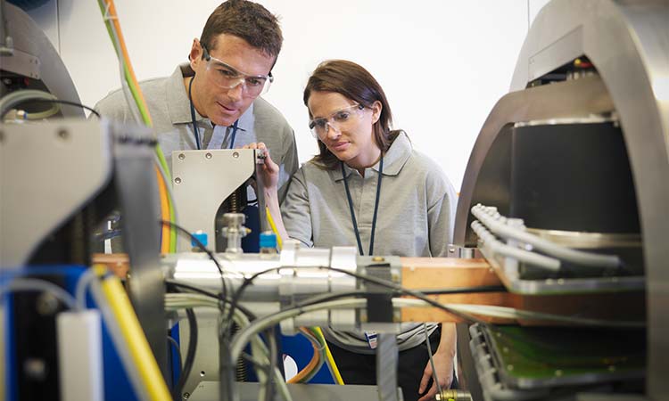 Photo: engineers working on a piece of machinery