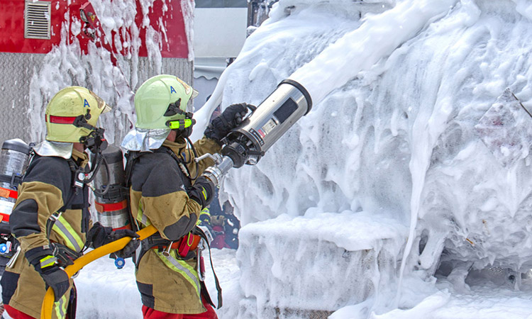 Photo: Firefighters using foam