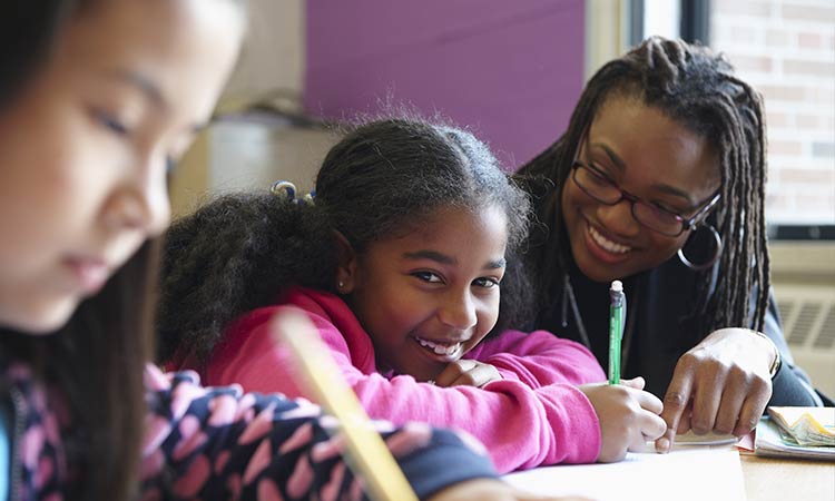 Photo: female stem students working in class