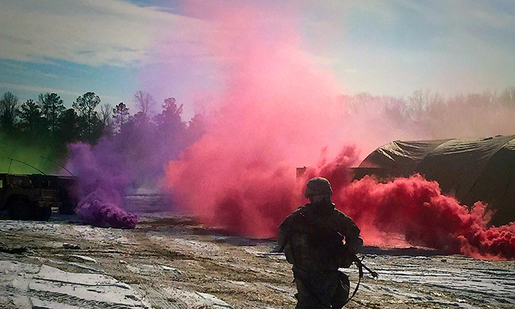 Photo: Ground soldier with flares in background