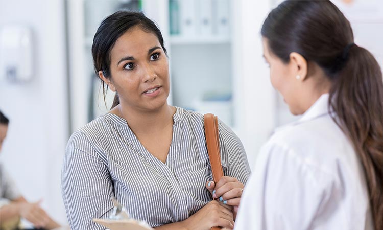 Photo: a healthcare researcher having a discussion with a patient