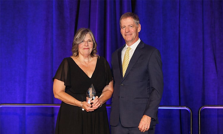 alt=inventor of the year katherine palmer standing with battelle president and ceo lou von thaer celebrating her work with carbon nanotube (CNT) materials to create aircraft anti-icing systems (HeatCoat™)
