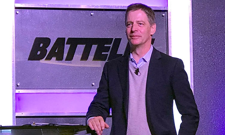 Photo: Lou Von Thaer in front of Battelle Logo