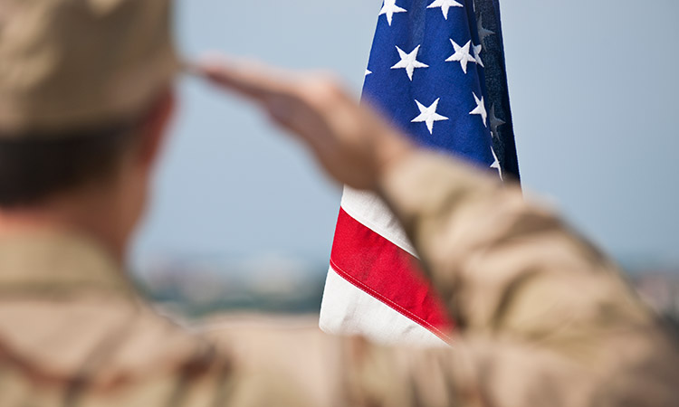 Photo: Armed Forces member saluting the American flag