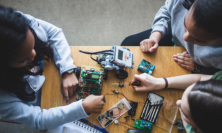 Photo: Students examining robots