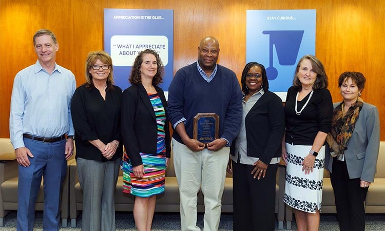 Photo: Battelle employees accepting the supplier of the year award from Intelleges