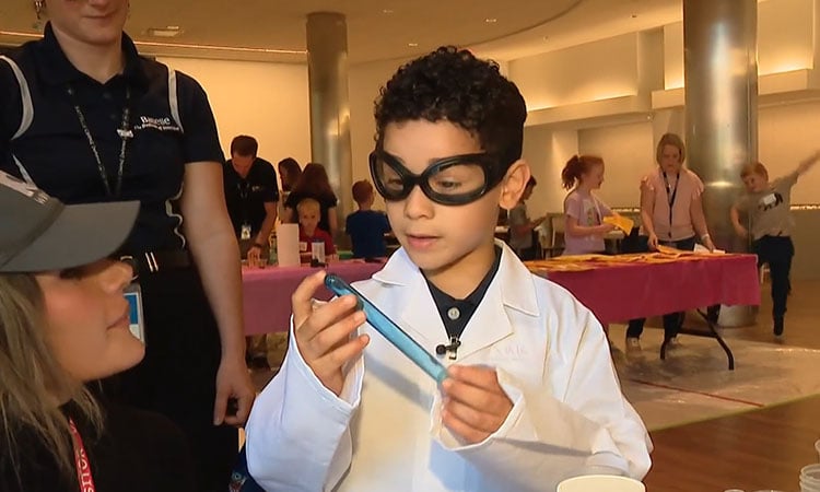 boy holding blue test tube