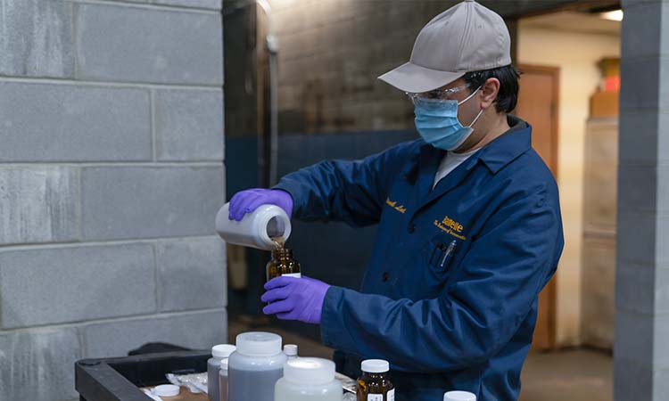 Photo: Battelle pfas expert vivek lal sampling water for PFAS Annihilator