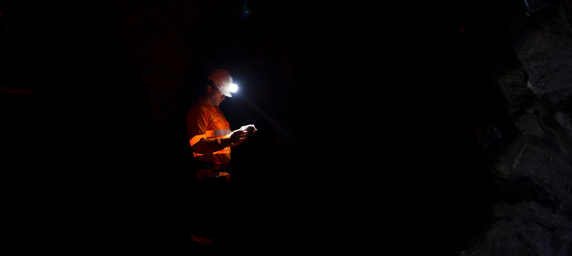 Photo: Geologist examining bedrock