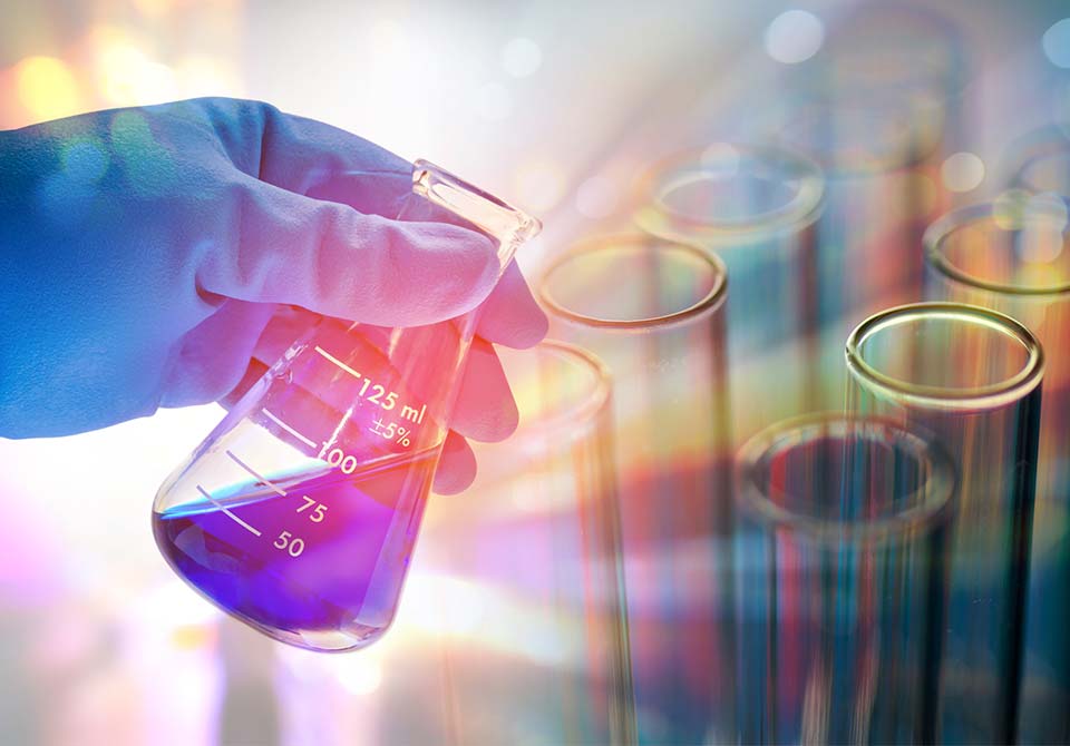 Photo: scientist holding a beaker