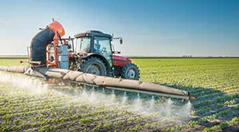 Picture: Tractor spraying a field with chemicals.