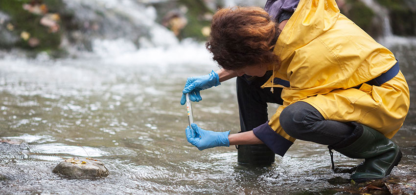Photo: Battelle environmental tech taking a water sample
