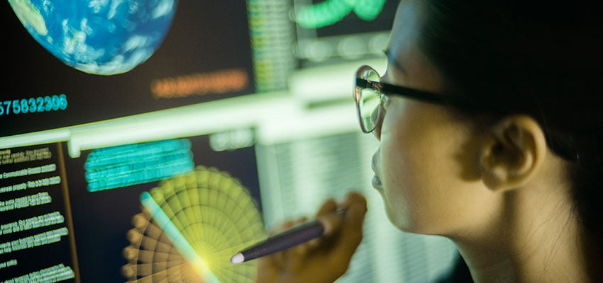 Photo: Battelle research scientist examining dashboards with climate resiliency data