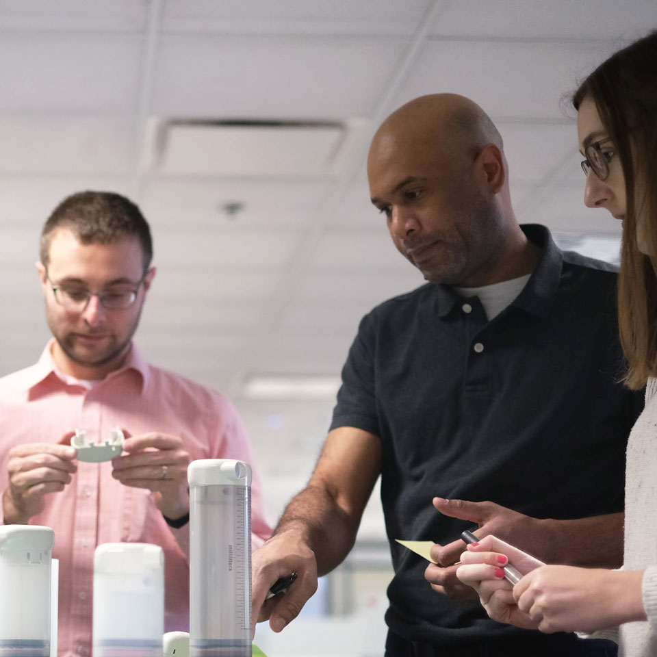 Image: Battelle medical device experts examining a startup prototype