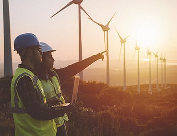 Photo: Battelle experts viewing a research site with wind turbines