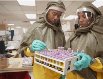 Photo: Lab workers observing safety protocols