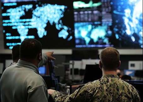 Photo: 2 military members discuss data