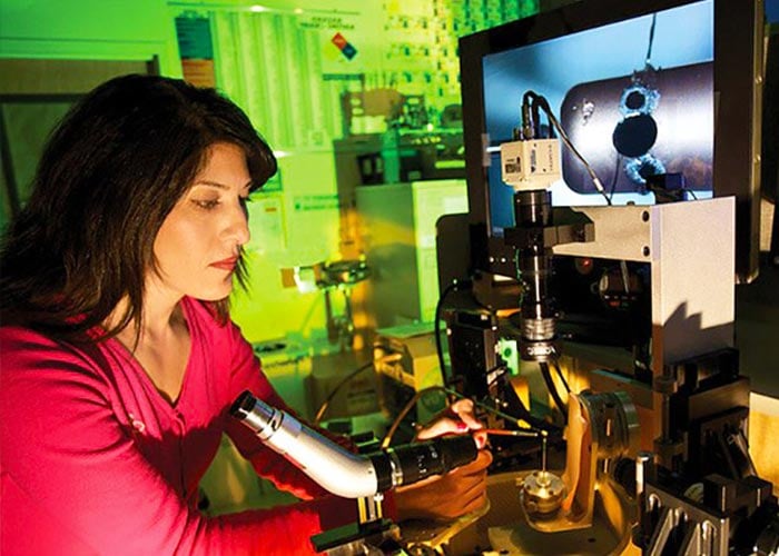 Photo: three scientists talking in a lab