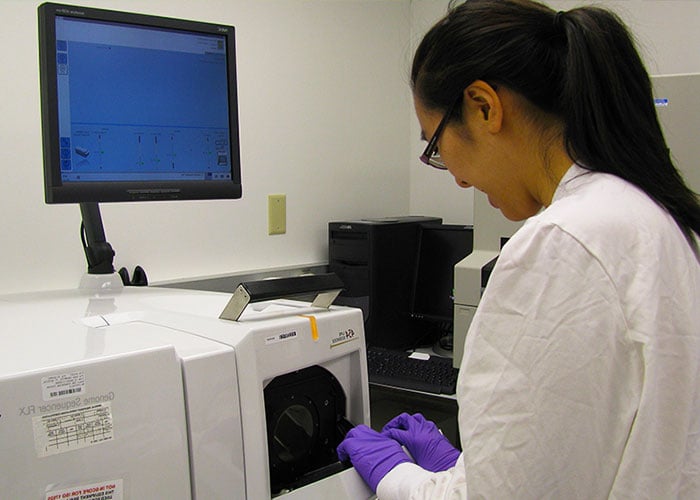 Lab Management Call-Out Photo: three scientists in a lab analyzing data