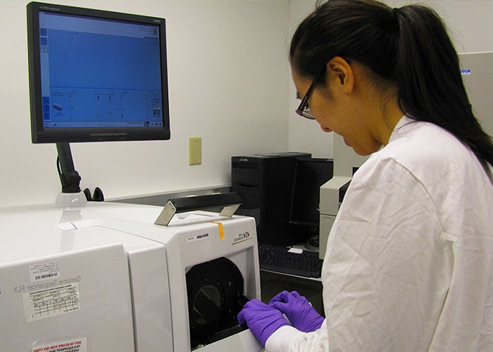 Photo: three scientists in a lab analyzing data