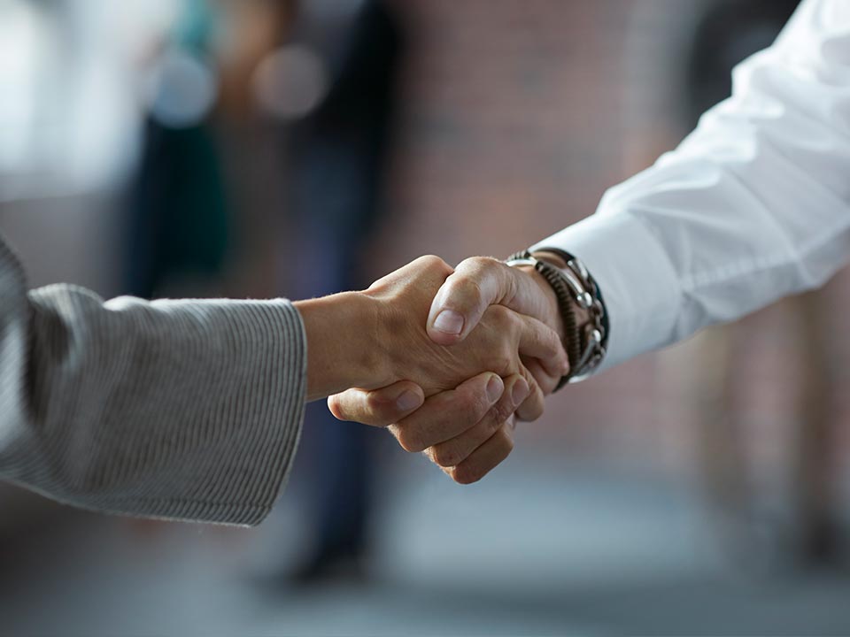 Partner-with-us-call-out alt=a close up of two business partners shaking hands